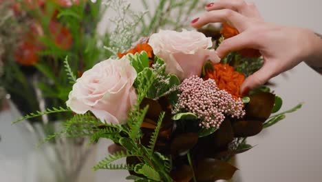 Florist-making-final-adjustments-on-a-bouquet-for-Valentine's-day