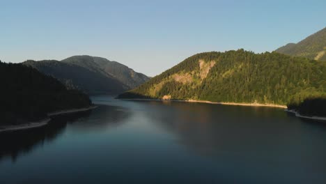 a-professional-looking-aerial-over-Sylvensteinsee-in-the-german-alps,-bavaria-while-sunset