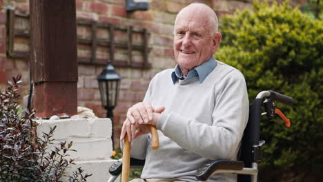elderly man sitting in a wheelchair in a garden