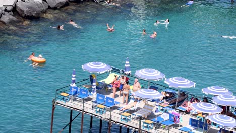 people enjoying the sea and sunbathing