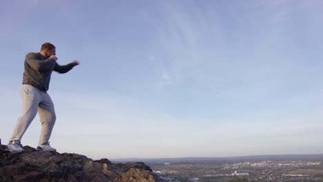 man boxing on mountaintop