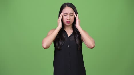 young beautiful asian businesswoman having headache