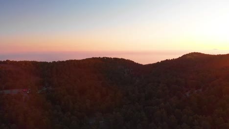 Aerial-view-over-Mount-Olympus-with-red-sunset-glow