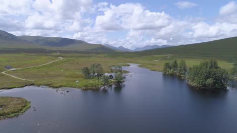 pull back aerial reveal shot over loch ossian looking across rannoch moor