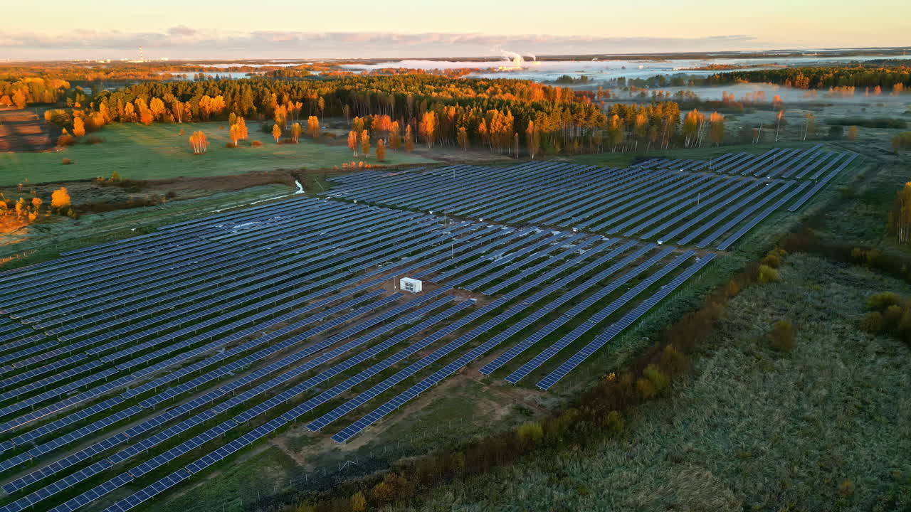 Solar farm at sunset with vast panels in serene countryside landscape