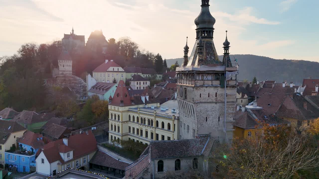 Capture the medieval charm of Sighisoara, Romania, with this stunning drone footage. The camera glides over the historic city