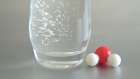 water illustrated with a hydrogen and oxygen atom which produces a molecular structure.