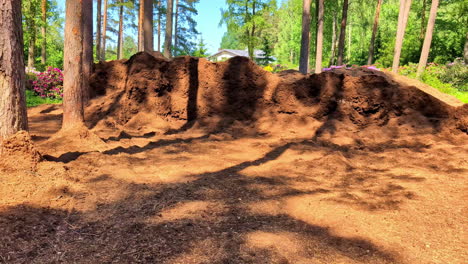 mountains of dirt in a forested construction area in progress in suburban houses