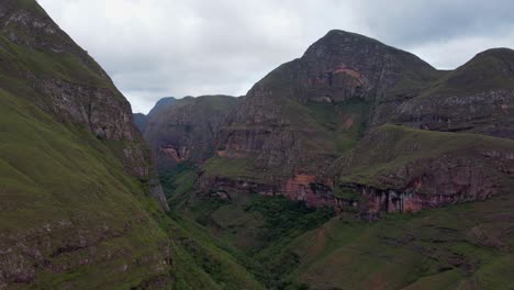 Rotating-aerial-reveals-tall-steep-eroded-mountain-chasm-in-Bolivia