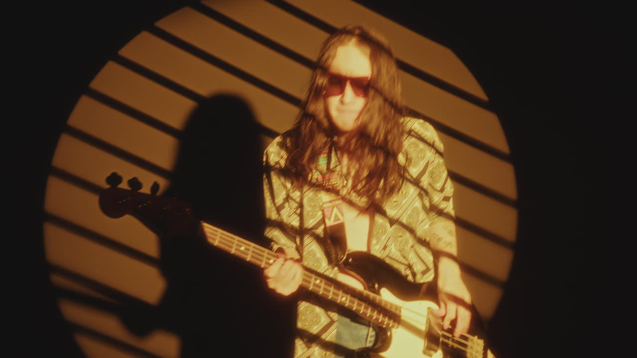 Indie Musician Playing the Guitar and Rocking in Yellow Spotlight
