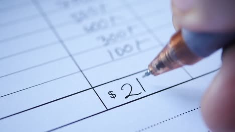 a man writes payment due in a paper form