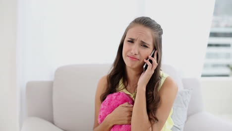 Young-woman-being-dumped-on-the-phone-on-the-couch