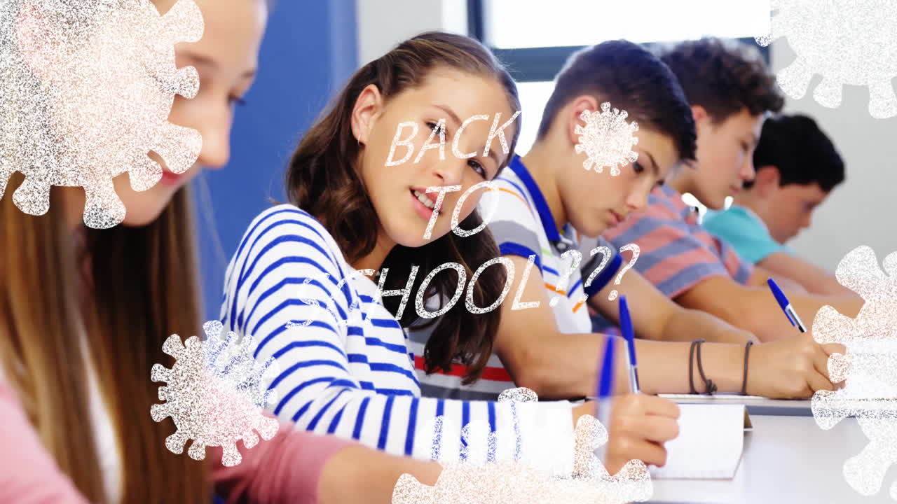 In school, students writing with animation of Back to School and snowflakes overlay