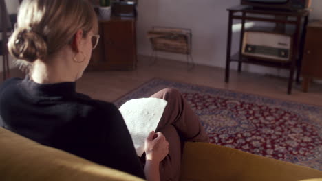woman reading a letter in a vintage living room