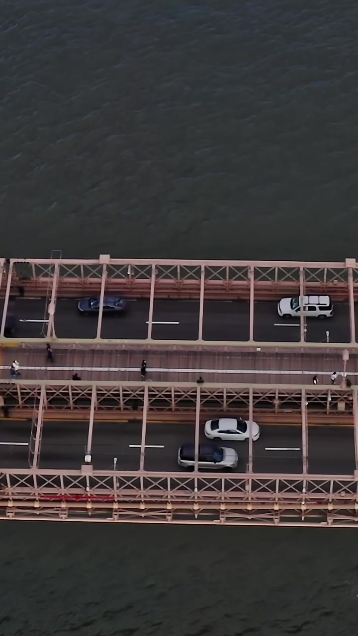 Brooklyn Bridge view from above with traffic and pedestrians in NYC