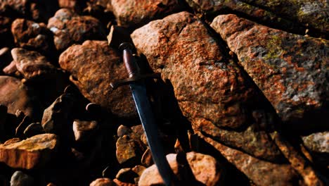 old dagger on the rock at sunset