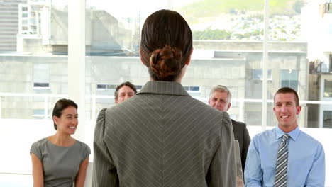 happy business people looking at camera during presentation