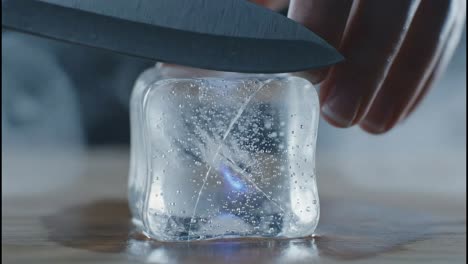 a knife cutting into an ice cube