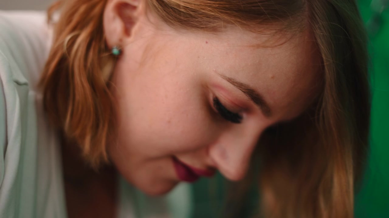 Close-up Portrait of a Young Woman Looking Down