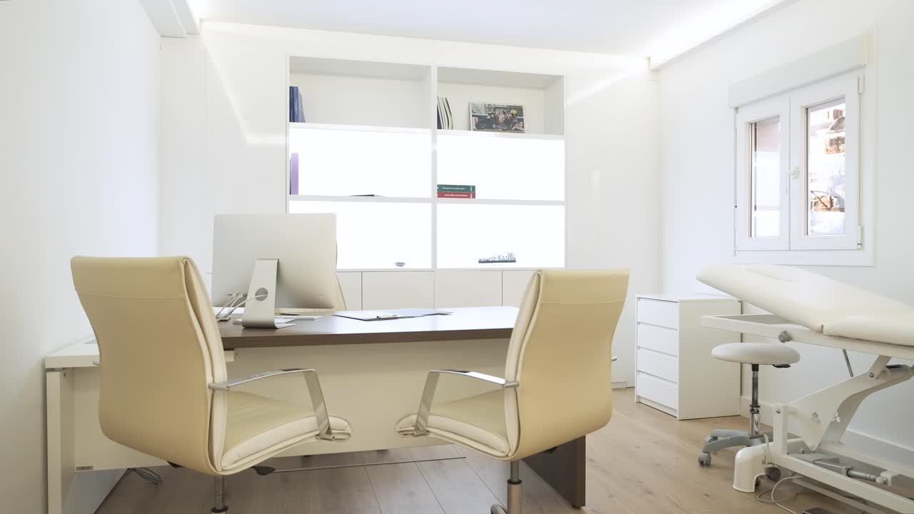 Interior of spacious clinic with chairs at computer desk