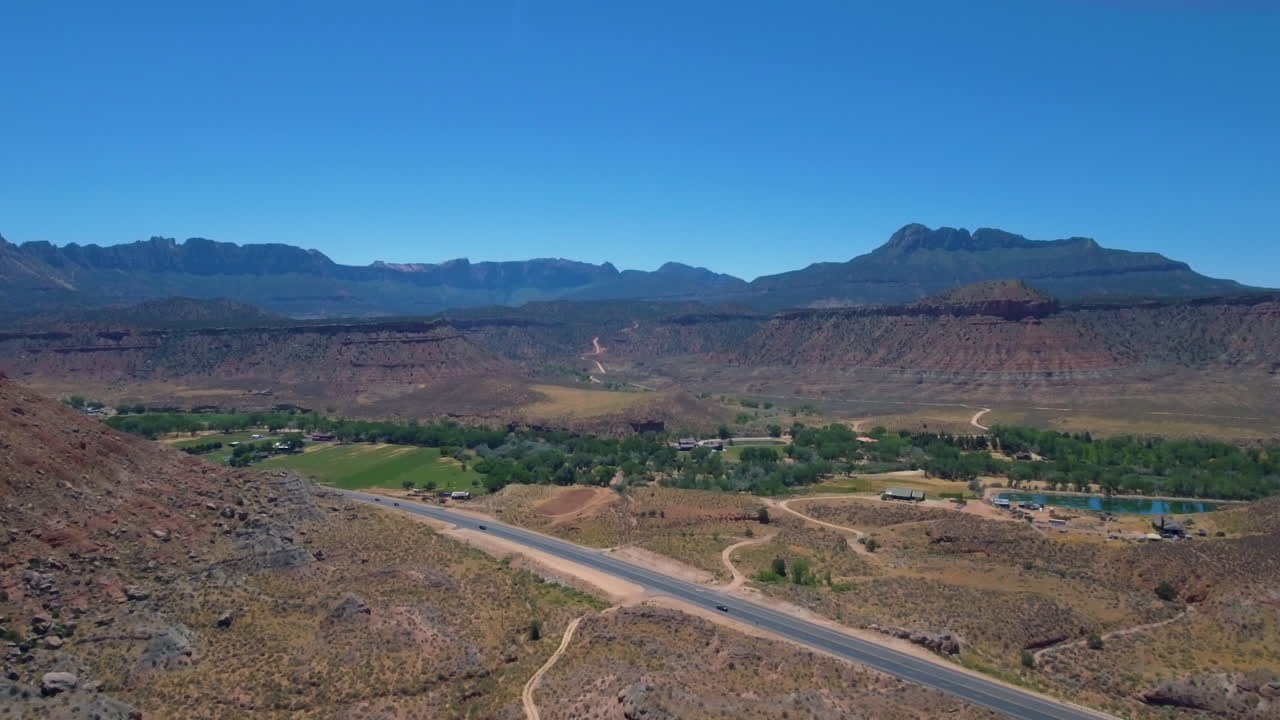 유타 남부에 위치한 산맥을 배경으로 마운트 시온을 통과하는 도로의 드론 샷