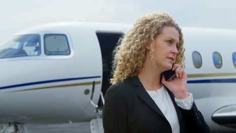 businesswoman talking on mobile phone at terminal 4k