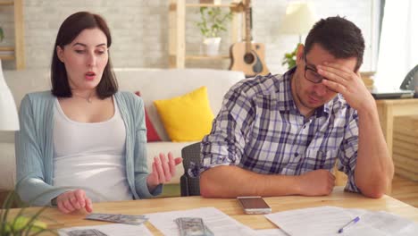 close up young couple concerned and tense,doing the calculations documents with bank papers and calculator