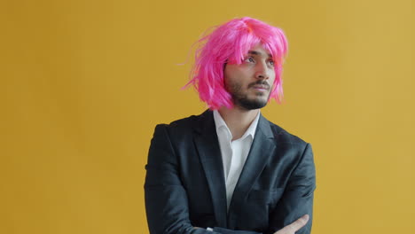 man in a suit with pink wig
