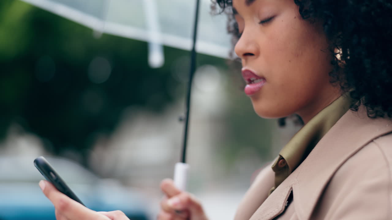 Phone, umbrella and a woman waiting for a taxi