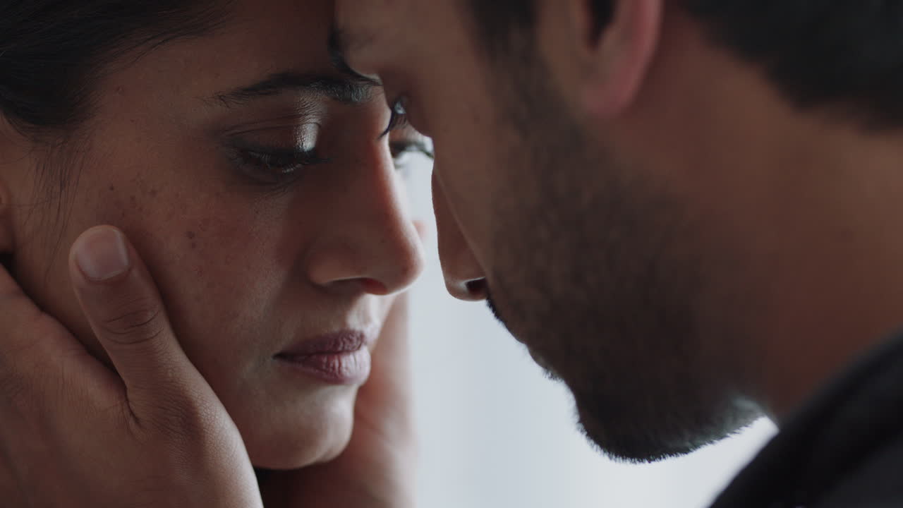 unhappy couple having relationship trouble man caressing womans face showing affection