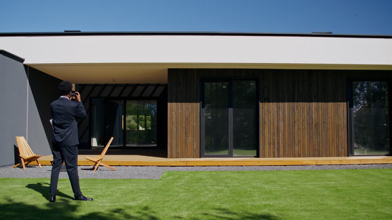 Real Estate Agent Photographing Modern Home Exterior