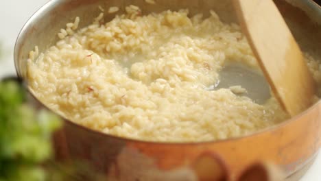 unrecognizable cook preparing risotto in pan