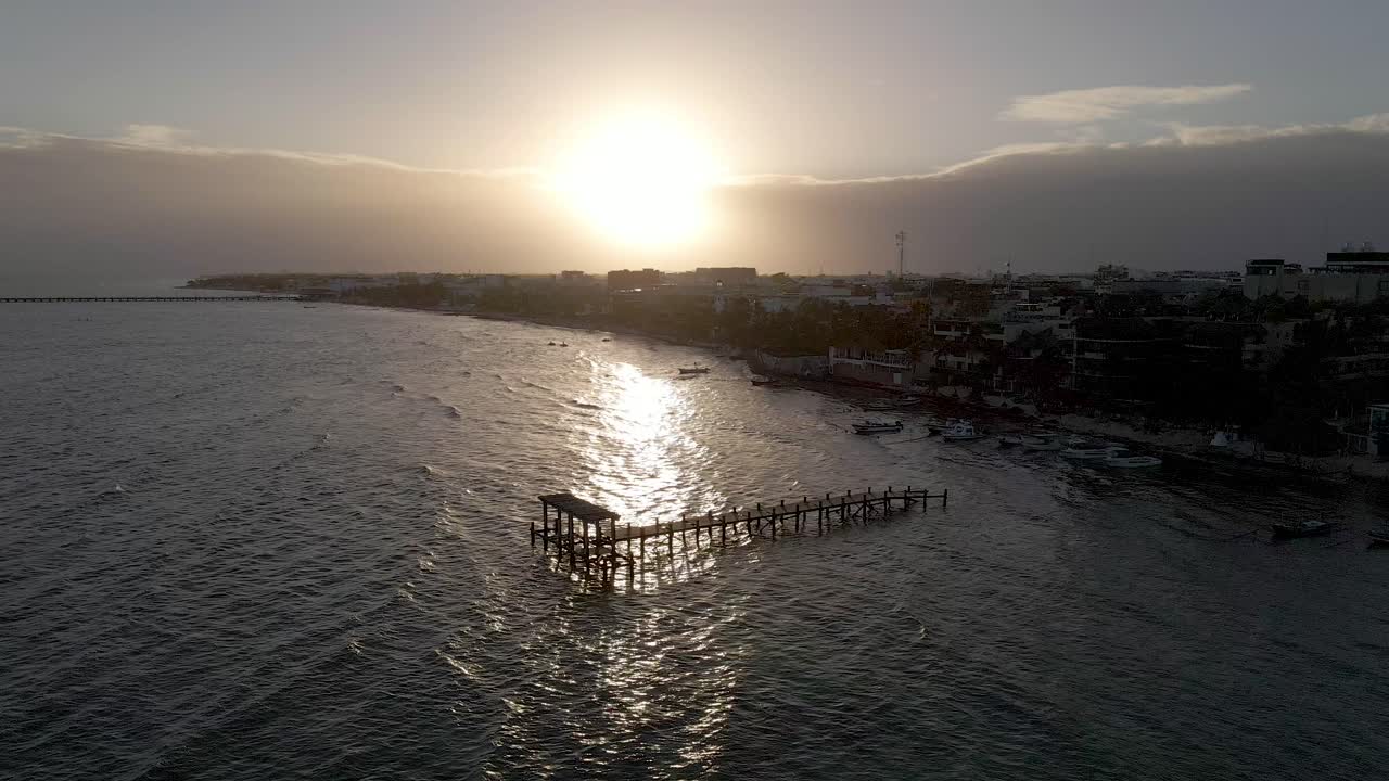 Pier or Dock in the ocean during sunset, silhouette aerial drone shot, Playa del Carmen, Yucatan, Mexico