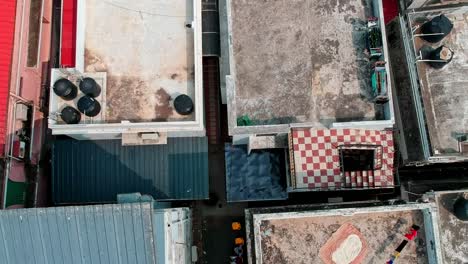 Aerial-view-of-crowded-city-house-,-Drinking-water-supply-tanks-placed-on-top-of-houses-,-Clothes-hanging-out