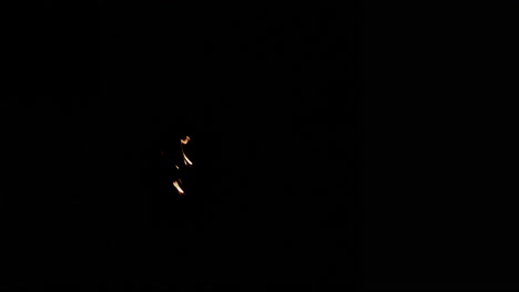 small group of slow motion flames burning on left of screen that slowly burn out.