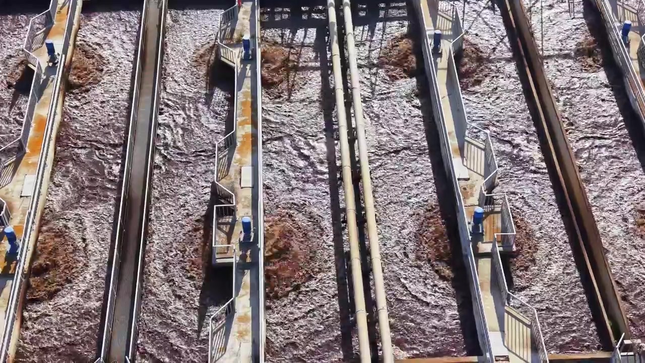 Water treatment process at facility with multiple tanks during day