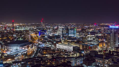 Aerial-night-time-hyperlapse-of-Birmingham-city-centre-with-aircraft-in-the-distance