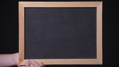 hand holding empty blackboard