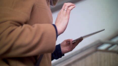 Woman-with-pad-going-upstairs-in-subway