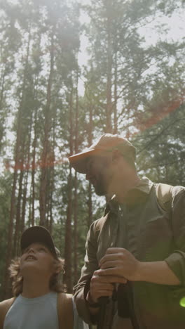 father and son hiking in forest