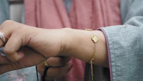 woman wearing a gold bracelet