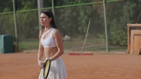 female tennis player practicing serve on outdoor court