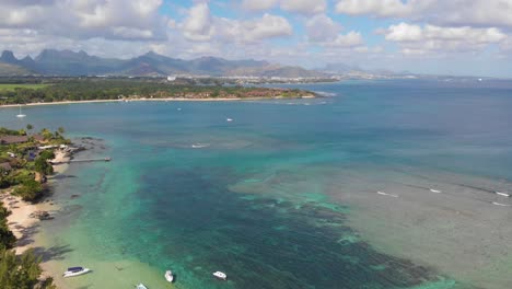 Aerial-4K-Wide-shot-of-Beach-with-clear-torquise-water-with-mountains-in-the-background-in-troipical-paradise-in-Balaclava-Mauritius