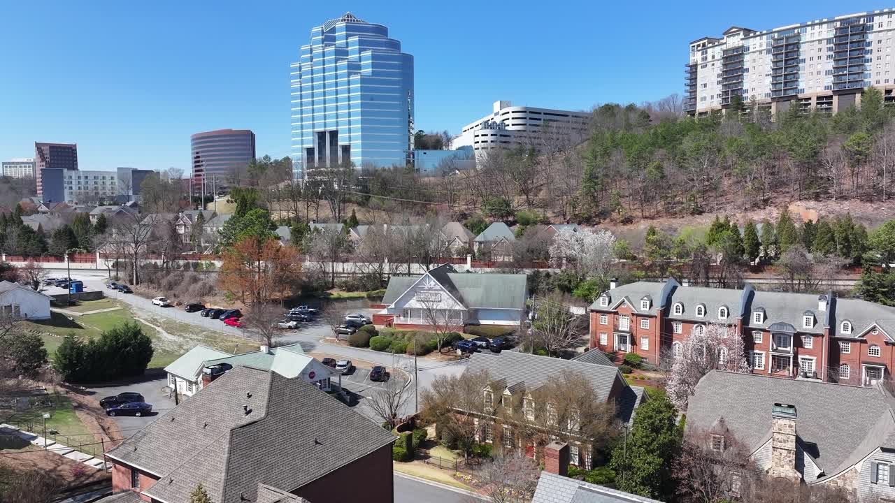 Vinings village buildings and street view with highrise buildings at back, Atlanta, Georgia, Aerial view, Establishing shot