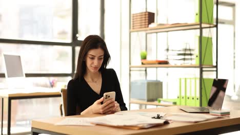 woman relaxing and stretching at her office desk