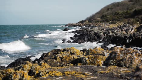 waves crashing on rocky coastline scenery, slow motion