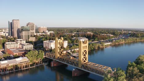 panning aerial shot of the tower bridge with downtown sacramento in the background