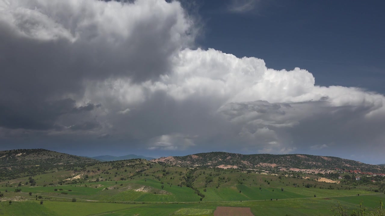 Time Lapse of Dramatic Storm Clouds Over Rolling Green Hills