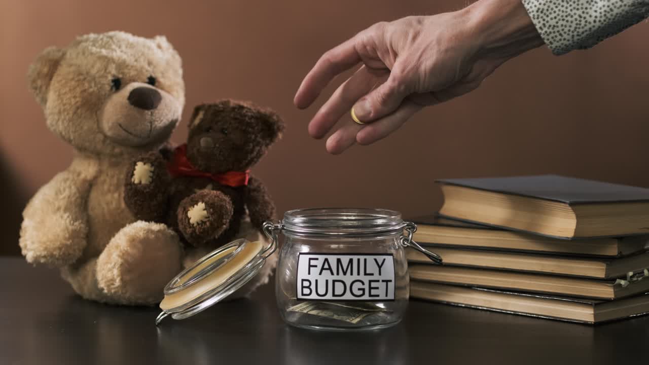 Man Puts Coins into Empty Jar for Family Savings