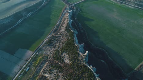 aerial view of hills, fields, and rock formations